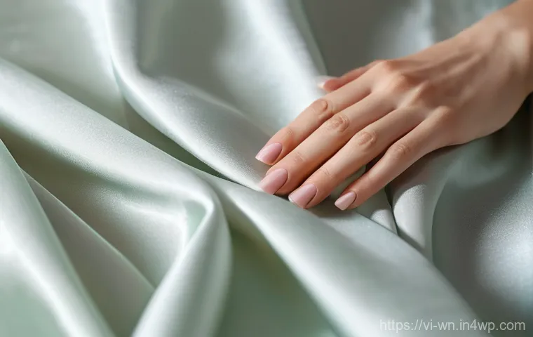 촉각적 요소가 브랜드 충성도에 미치는 영향 - A close-up shot of elegant hands, with well-manicured nails, gently caressing a piece of luxurious, ...