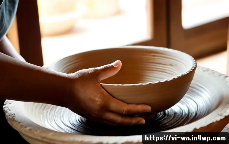 Home 11 촉각적 디자인과 감정적 연결 - Photorealistic close-up of a Vietnamese ceramic artisan’s hands gently exploring the textured surfac...